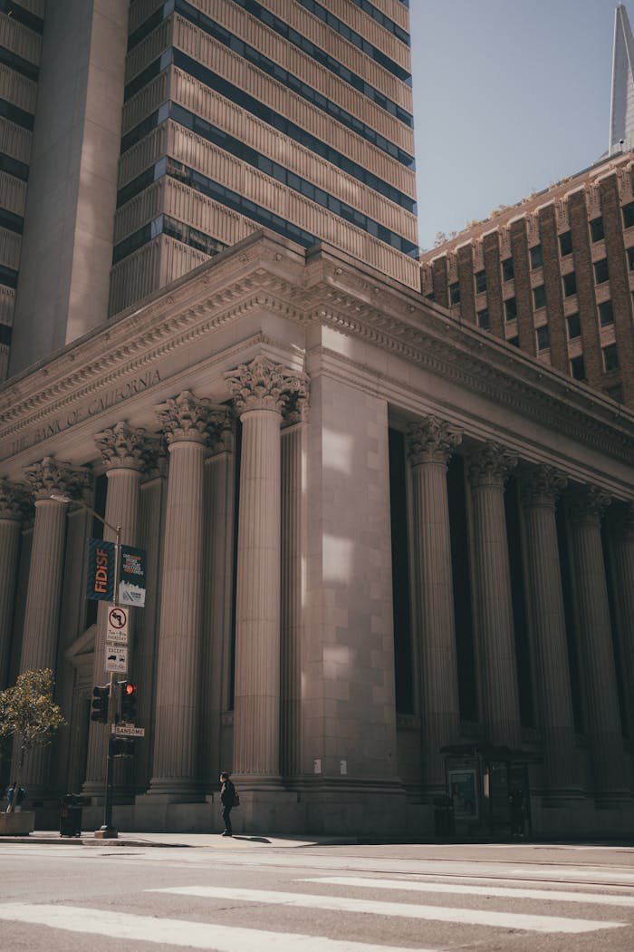 A majestic neoclassical courthouse with towering columns and intricate architecture captured on a city street.